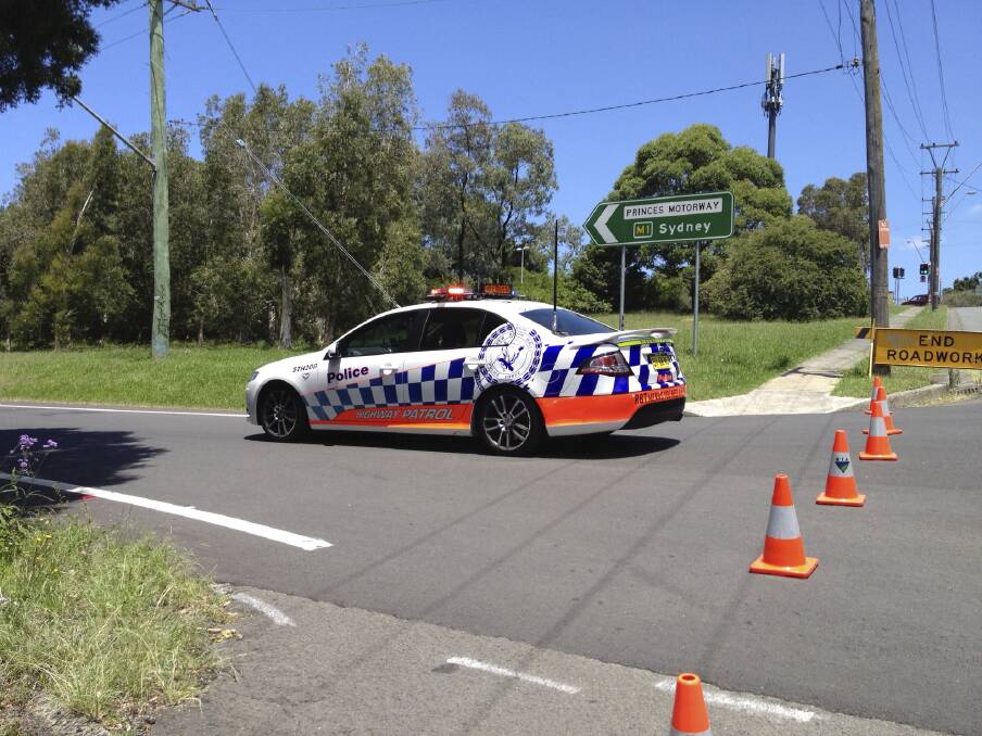 Police block the Robsons Road on-ramp onto the Princes Highway after a two-car crash. Picture ANDY ZAKELI