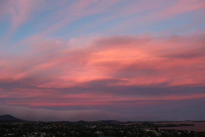 Smoky sunset over Wollongong. PICTURE: Carolyn Hitchcock