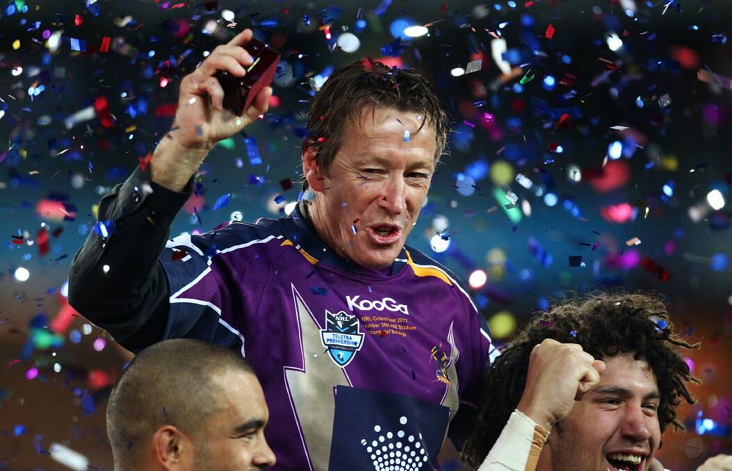 Storm coach Craig Bellamy celebrates with his team after the 2012 NRL Grand Final match.