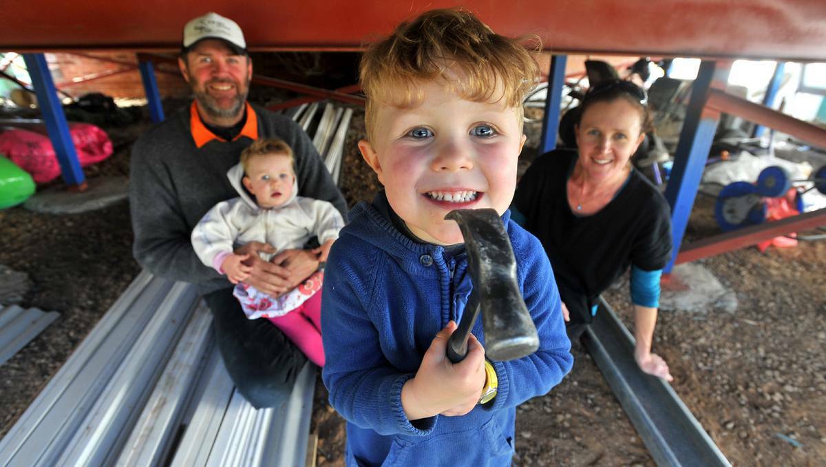 Simon Whyte with 18-month-old daughter Georgia, son Sydney, 4, and wife Andrea amid the construction that has included raising their North Wagga home to avoid flood damage. Picture: Addison Hamilton (DAILY ADVERTISER) 
