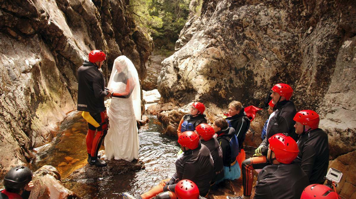 Jarrod Wells and Cassy Austin exchange their wedding vows in the World Heritage Dove Canyon, near Cradle Mountain, yesterday. A competition run by an adventure ...