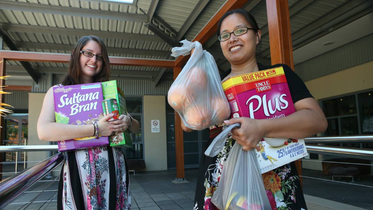 Thirroul Neighbourhood Centre co-ordinator Emily Messieh and Anna Watson are looking for volunteers to help run the centre’s emergency relief program. Picture: KIRK GILMOUR