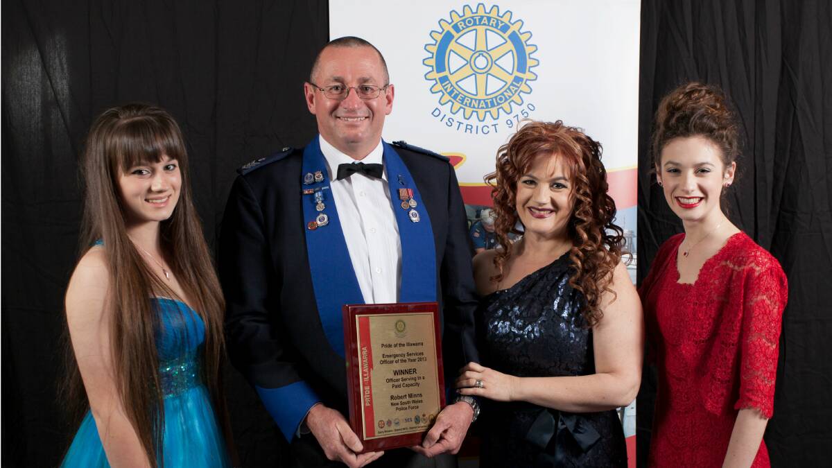 Pride of the Illawarra award winner Sergeant Robert Minns with his family. Picture: GLENN HENDERSON
