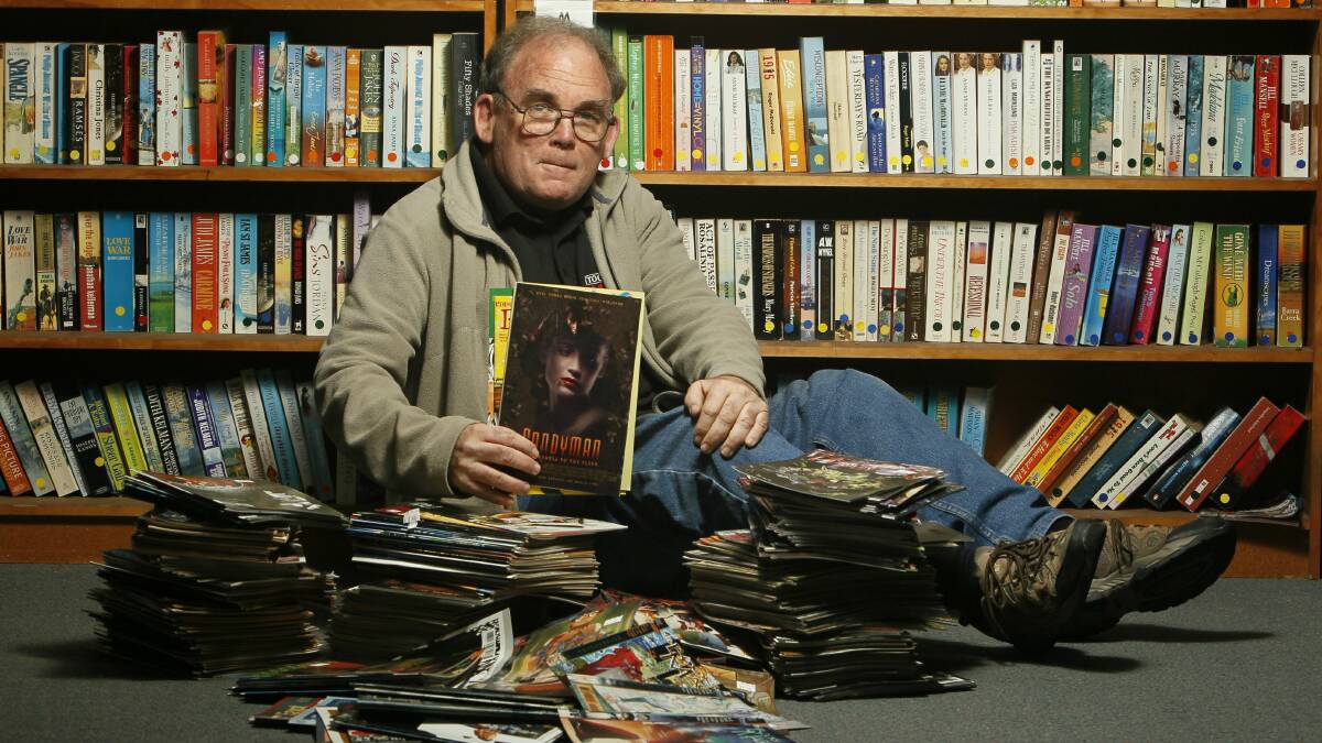  Lifeline volunteer Paul Hol with some of the hundreds of comics for sale at the Auburn Street store. Picture: DAVE TEASE