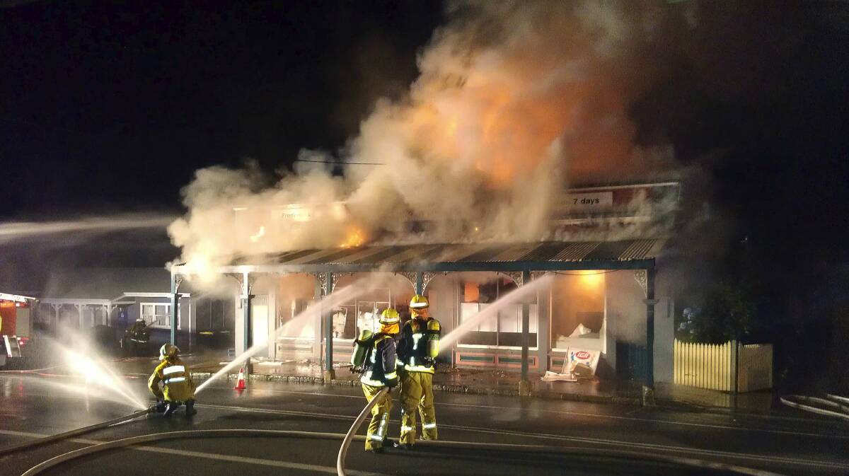 Fire crews attempt to extinguish a blaze at Jamberoo's IGA supermarket.
