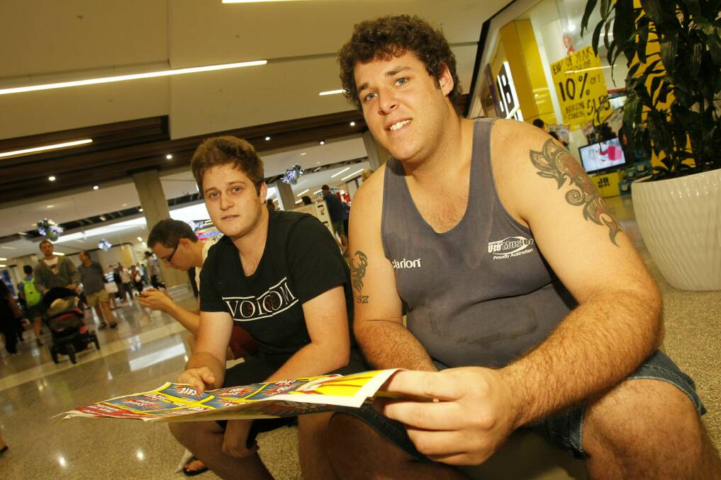Johnno Ezold of Horsley and Jake Barnes of Wollongong take a break outside JB Hi-Fi. Pictures: DAVE TEASE 