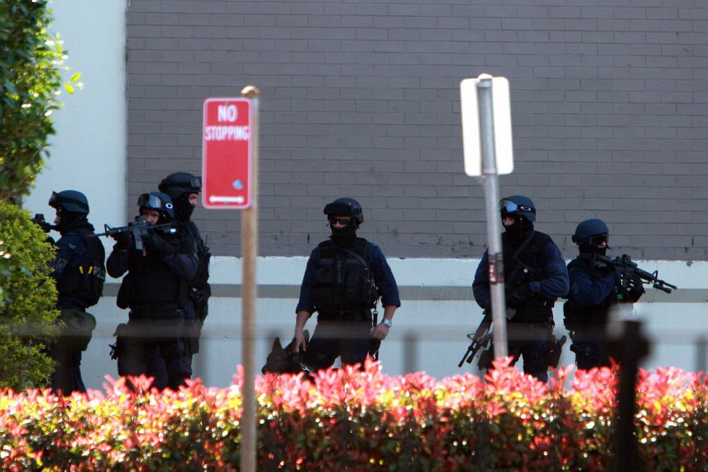 Police at a siege in Warrawong. Picture: SYLVIA LIBER