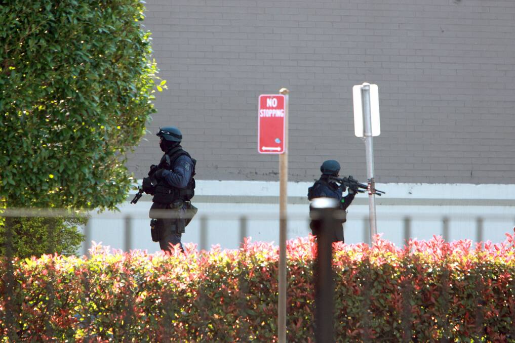 Armed tactical police at a siege in Warrawong. Picture: SYLVIA LIBER