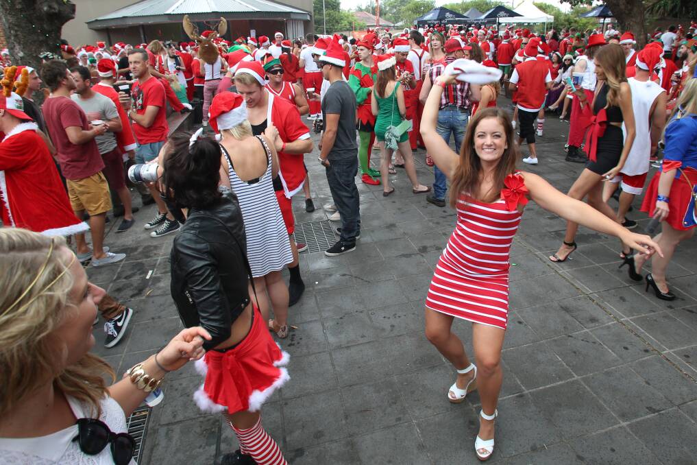 Revellers enjoy the start of the Santa Pub Crawl in Wollongong on Saturday. Picture: ADAM McLEAN