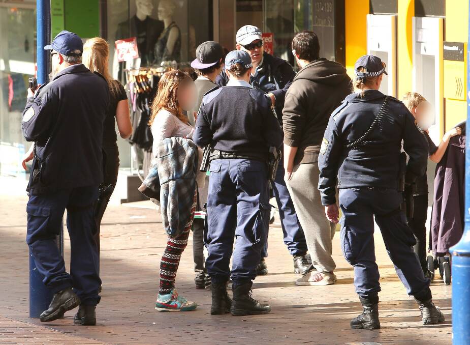 Police  in Wollongong’s Crown Street Mall earlier this year, checking people for identification.
