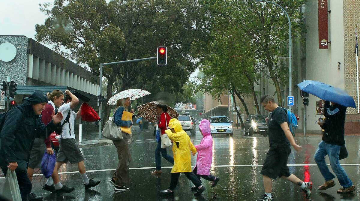 Pedestrians hurry across Burelli Street in Wollongong. Picture: KIRK GILMOUR