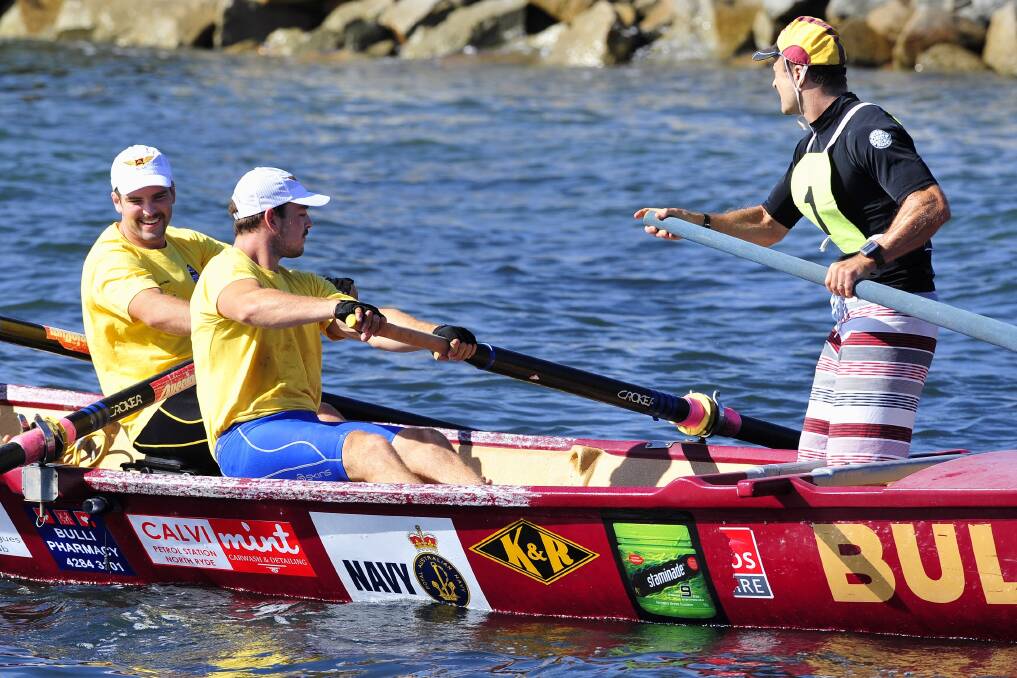 Crew members from one of the Bulli boats warm up before the start of the marathon earlier this week.