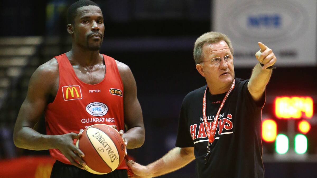 American import Kevin Tiggs gets the low-down at training with Wollongong Hawks coach Gordie McLeod yesterday. Picture: KIRK GILMOUR