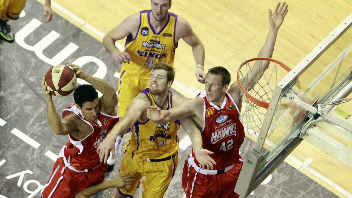 Hawks captain Oscar Forman goes for a basket as Dave Gruber backs up in the match against the Sydney Kings. Picture: ANDY ZAKELI