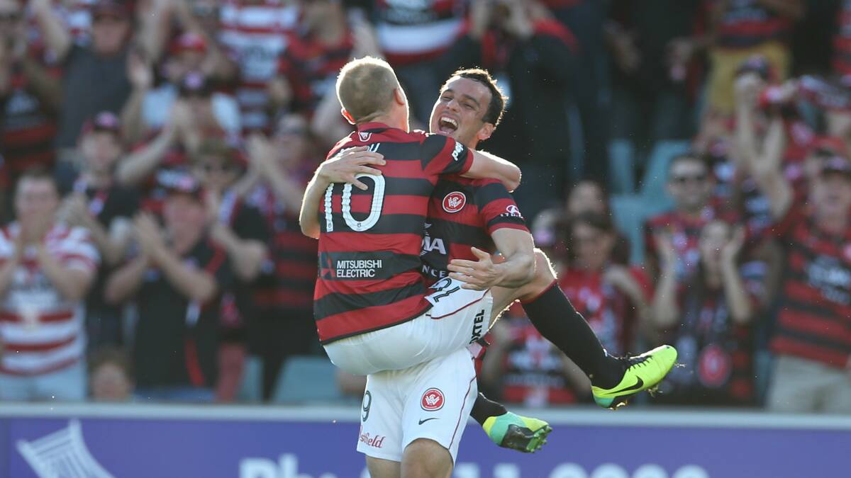 Wanderers' Aaron Mooy (No 10) celebrates his equaliser against Melbourne Heart with Mark Bridge. Picture: ANTHONY JOHNSON