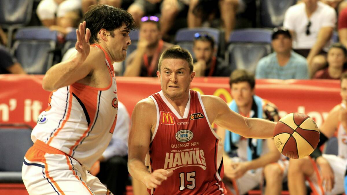 Cairns' Stephen Weigh gets up close and personal with Hawks sharpshooter Rotnei Clarke. Picture: ORLANDO CHIODO