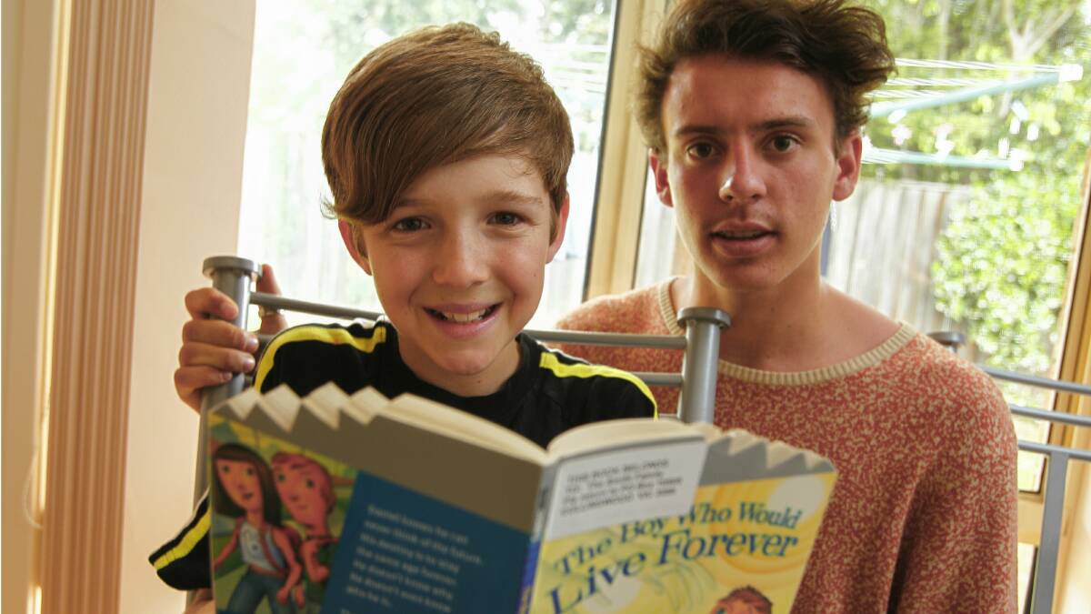 Conor Rogers, 11, has become more confident in his reading ability thanks to his mentor Clem McLernon, 16.  Picture: CHRISTOPHER CHAN