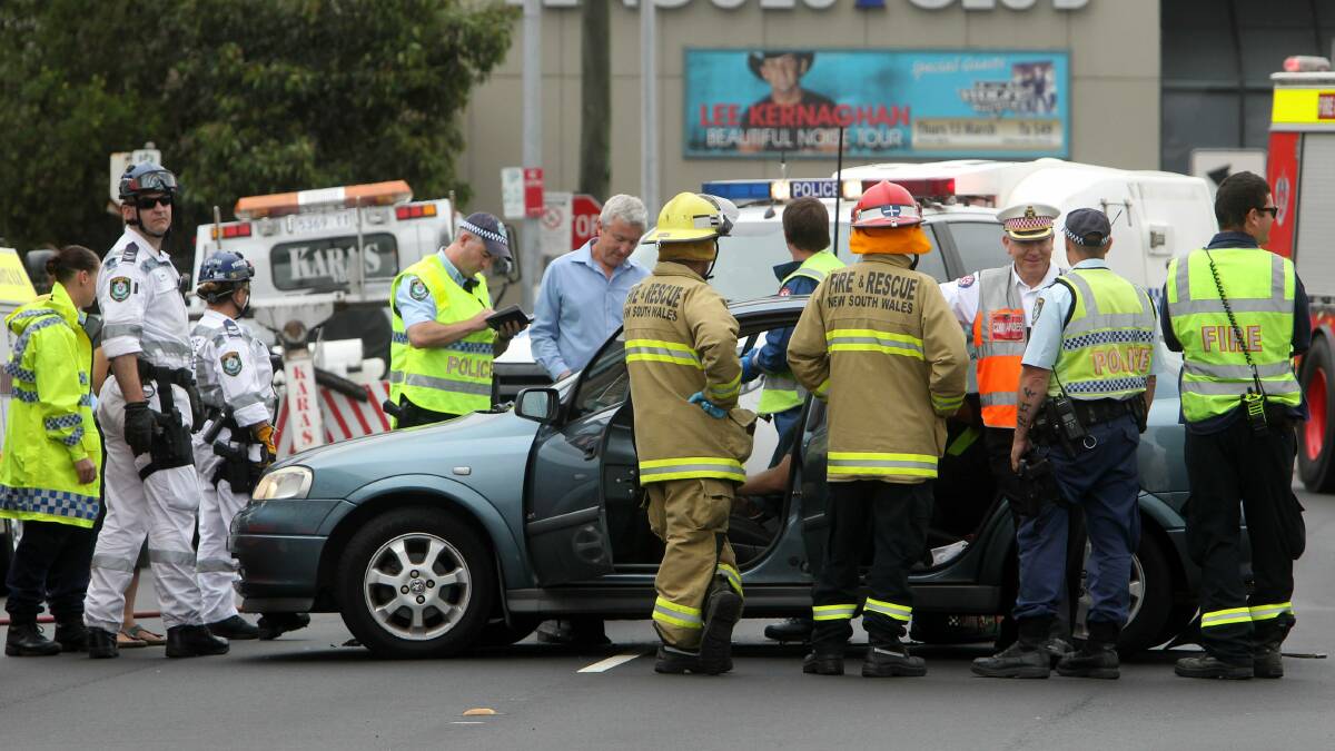 Emergency service personnel at the scene of a two-car crash yesterday. Picture: GREG TOTMAN