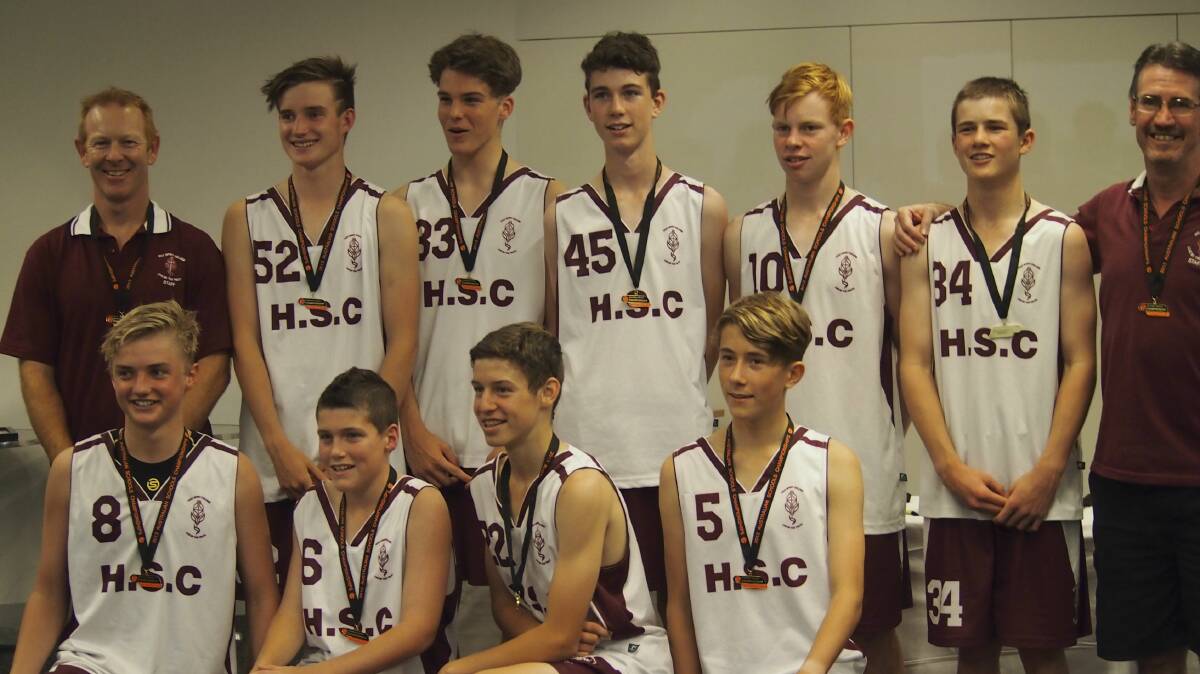 The Holy Spirit College under-15s team with their medals for winning the Australian Schools Basketball Championship.