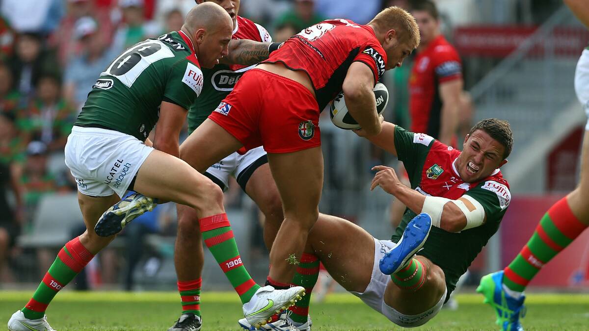 Dragons prop Jack De Belin fends of Souths counterpart Sam Burgess during the Charity Shield match at WIN Stadium. Picture: GETTY IMAGES