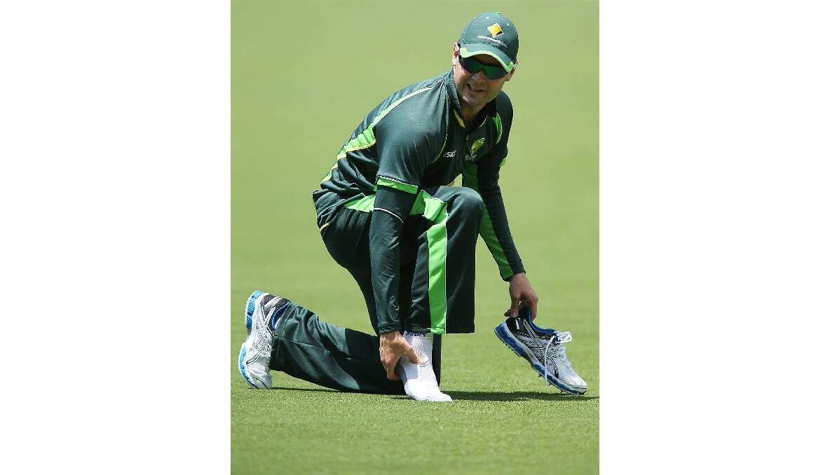 Captain Michael Clarke checks his ankle after rolling it at training yesterday. Picture: GETTY IMAGES