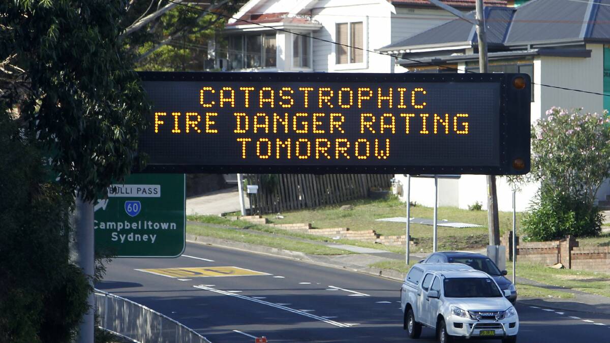 A RMS sign warns motorists of the fire danger along the Princes Highway this afternoon. Picture: ANDY ZAKELI
