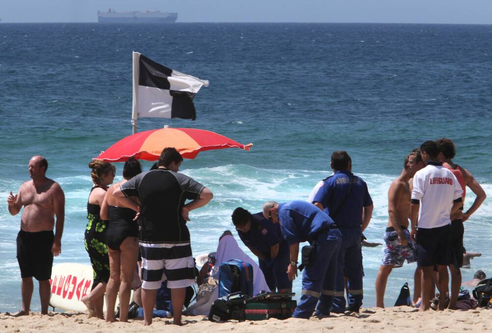 A woman is treated on Austinmer Beach. Picture: KIRK GILMOUR
