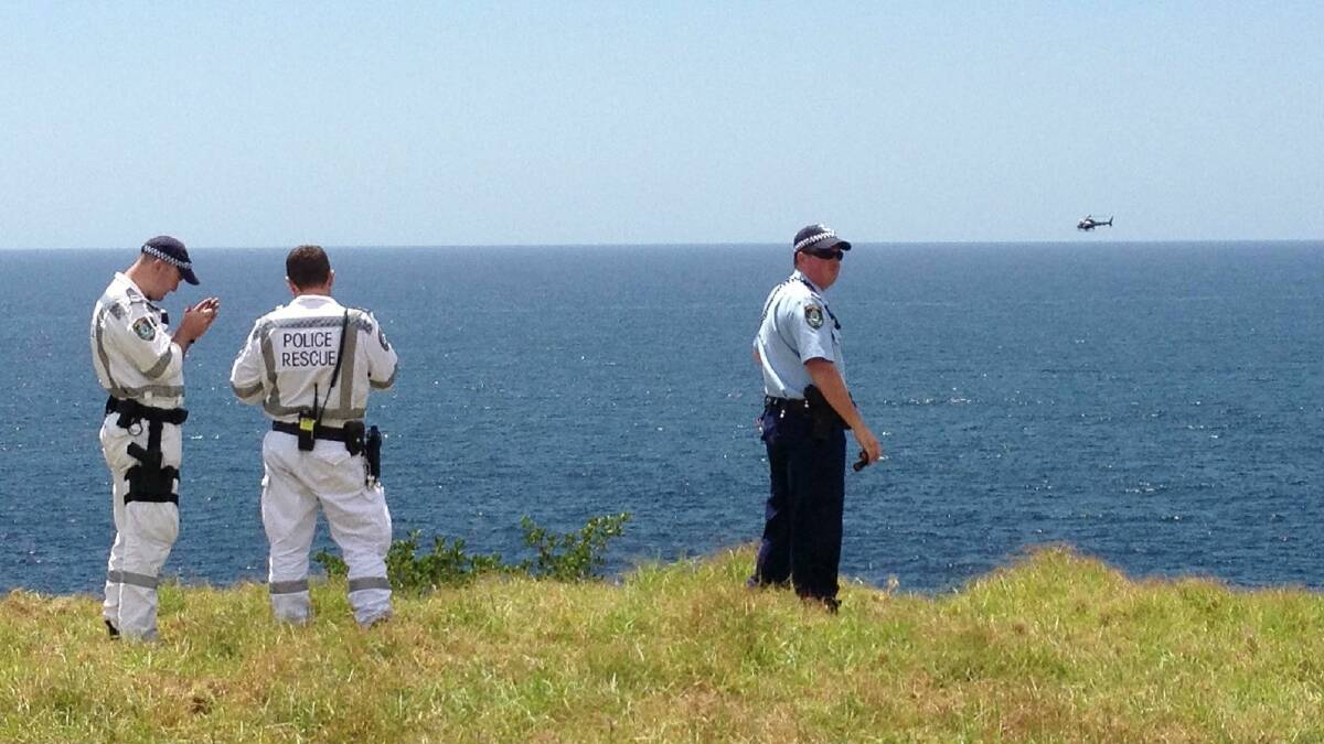 The Polair police chopper searches waters off the Kiama coastline. Picture: Andy Zakeli