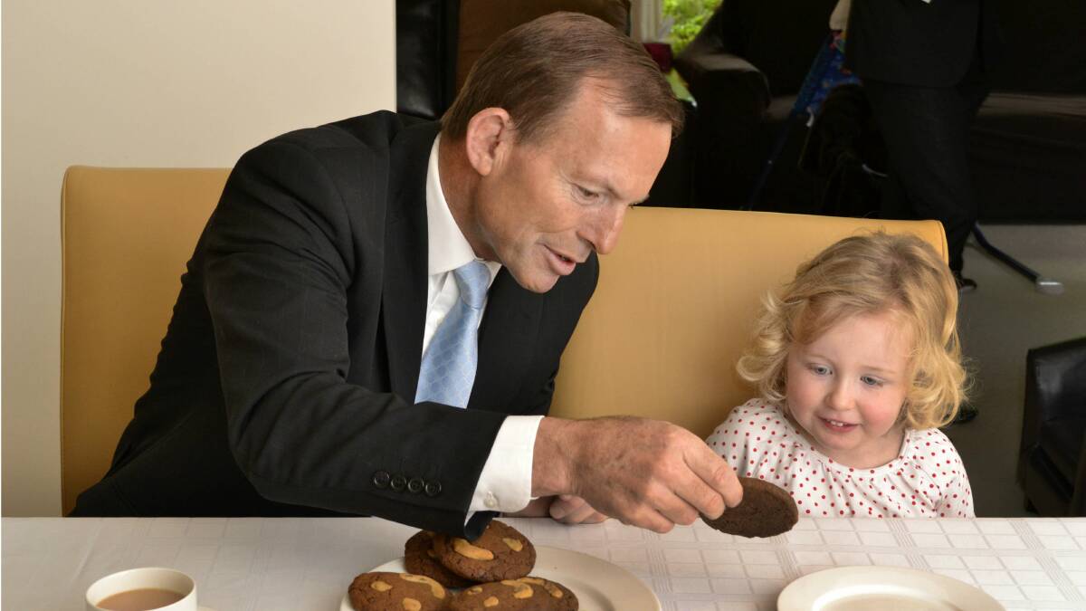 Tony Abbott meets three-year-old Natalia during a visit to Croydon late last year. Picture by ROB CAREW