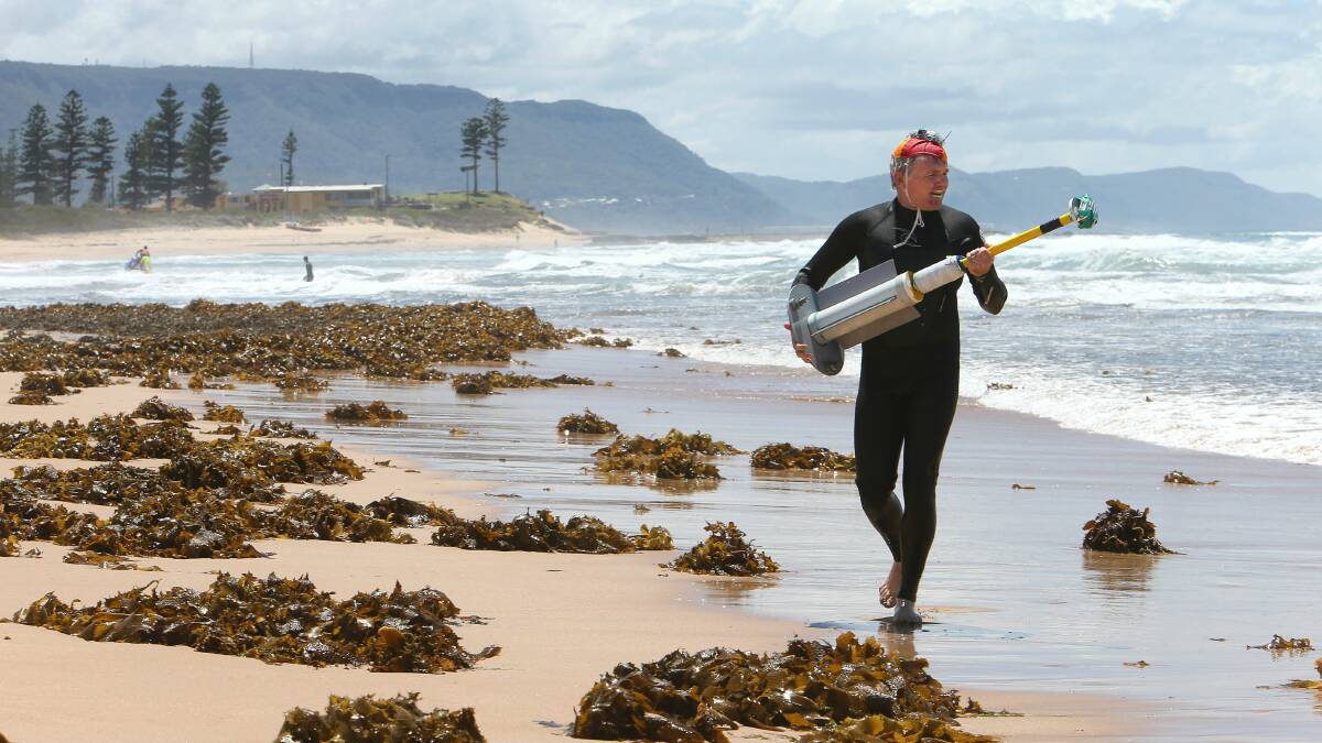 Dr Rob Brander on Bulli Beach with a GPS marker, which is used to map rip currents. Pictures: KIRK GILMOUR