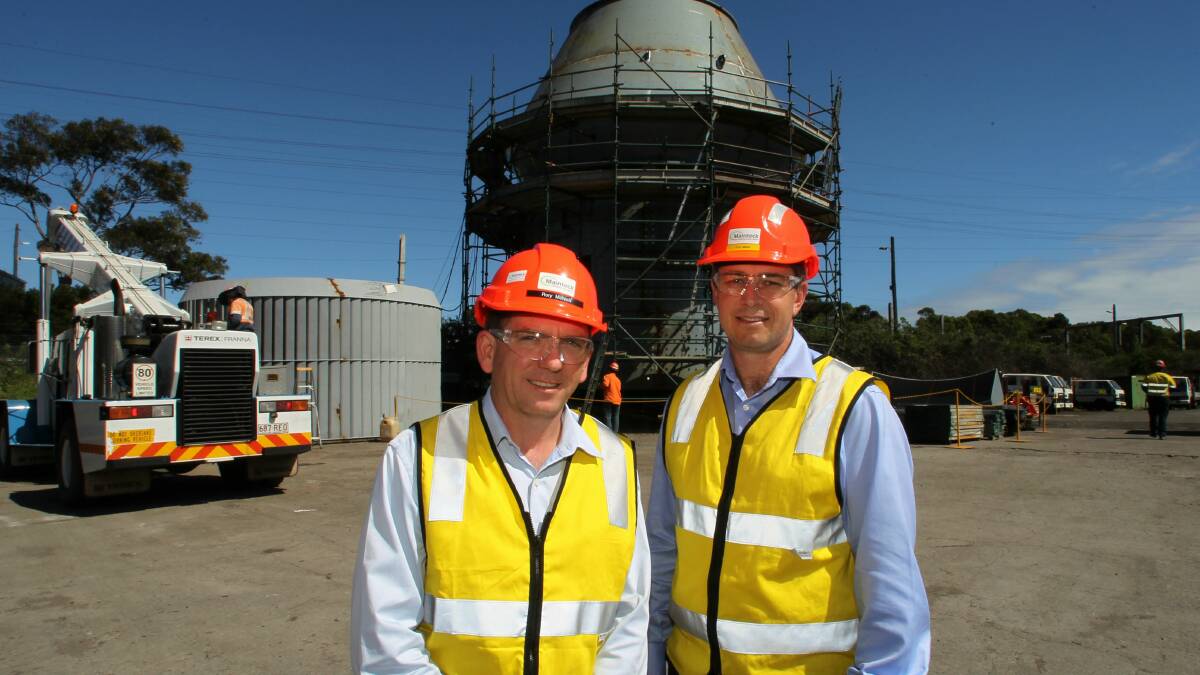 Rory McNeill and Tim Moss in front of a grinding mill which is to be lifted today. Picture: GREG TOTMAN