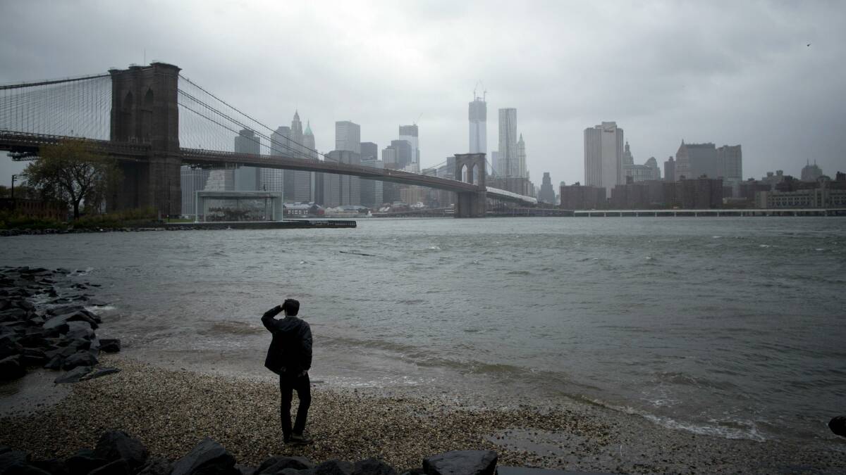 A man watches the storm roll in in New York City. Picture: REUTERS