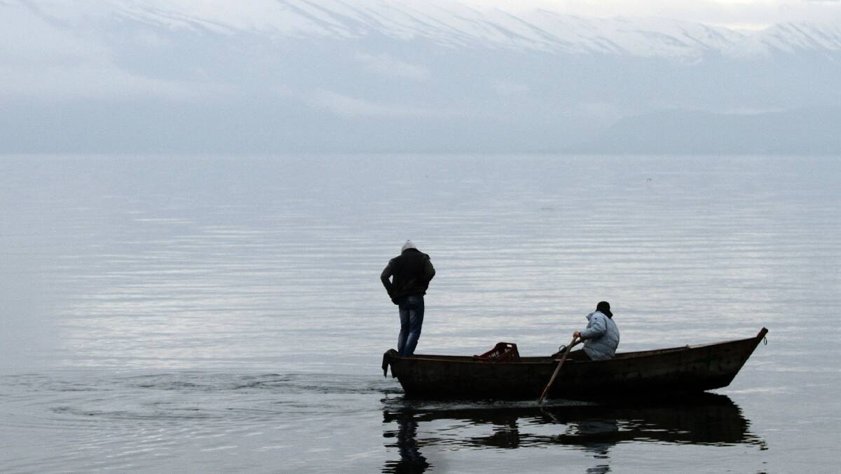 Albanian fisherman row their boat on the Ohrid lake. Picture: REUTERS