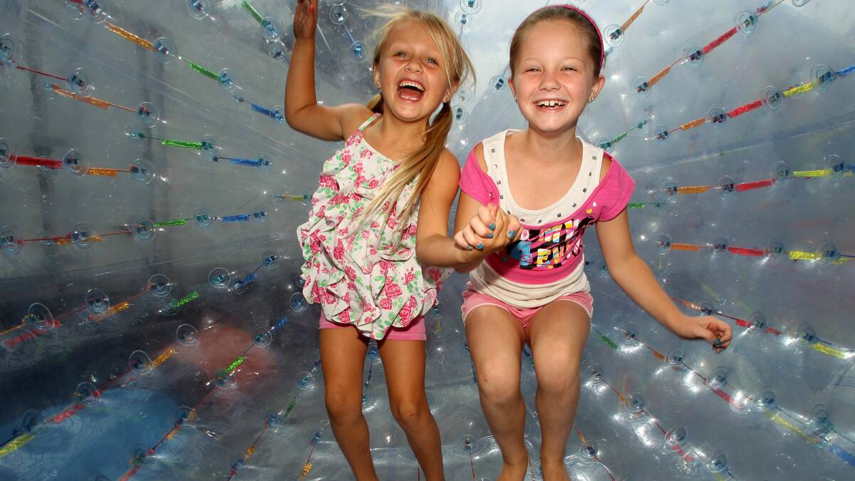 Zali Chambers, 6, left, and Lily Holland, 8, in the Zorb Ball at the Albion Park show. Pictures: GREG TOTMAN