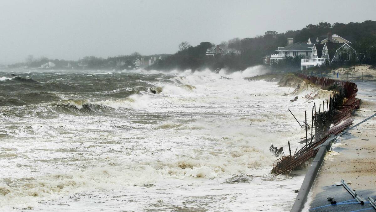 The storm surge breaks below homes in Shinnecock Hills, New York. Picture: REUTERS