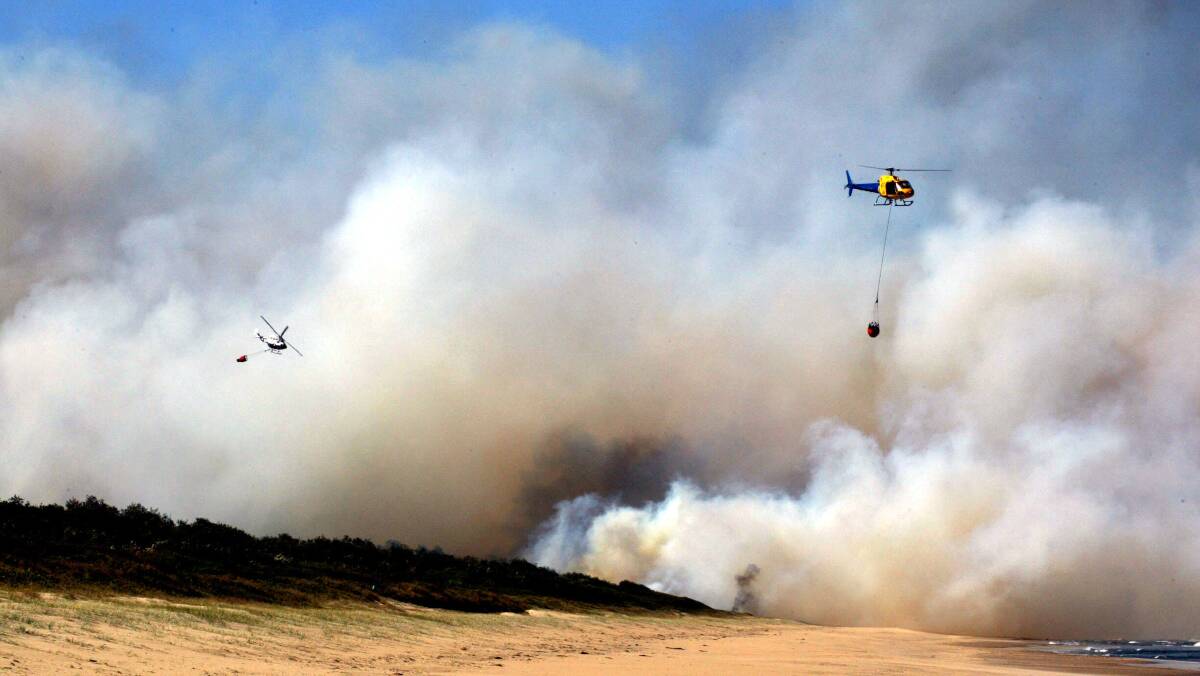 Water bombers battle a fire at Shoalhaven Heads Beach in 2002. Picture: ORLANDO CHIODO 