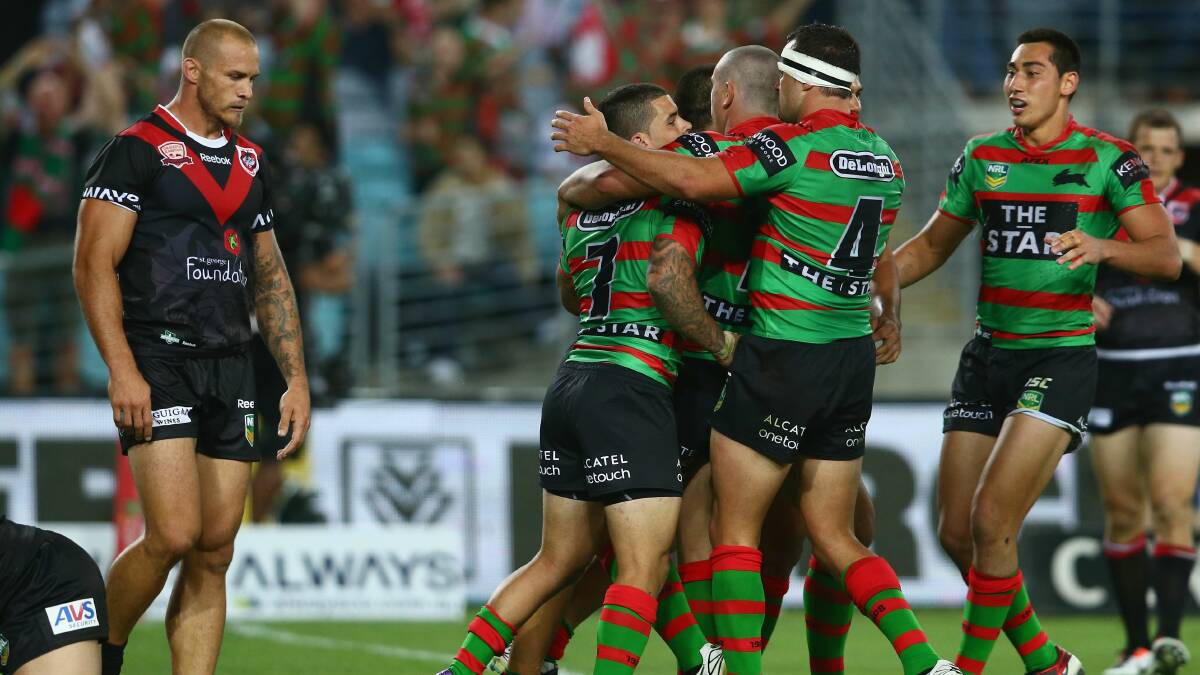 The Rabbitohs celebrate a try as Dragons centre Matt Cooper looks on. Picture: GETTY IMAGES 
