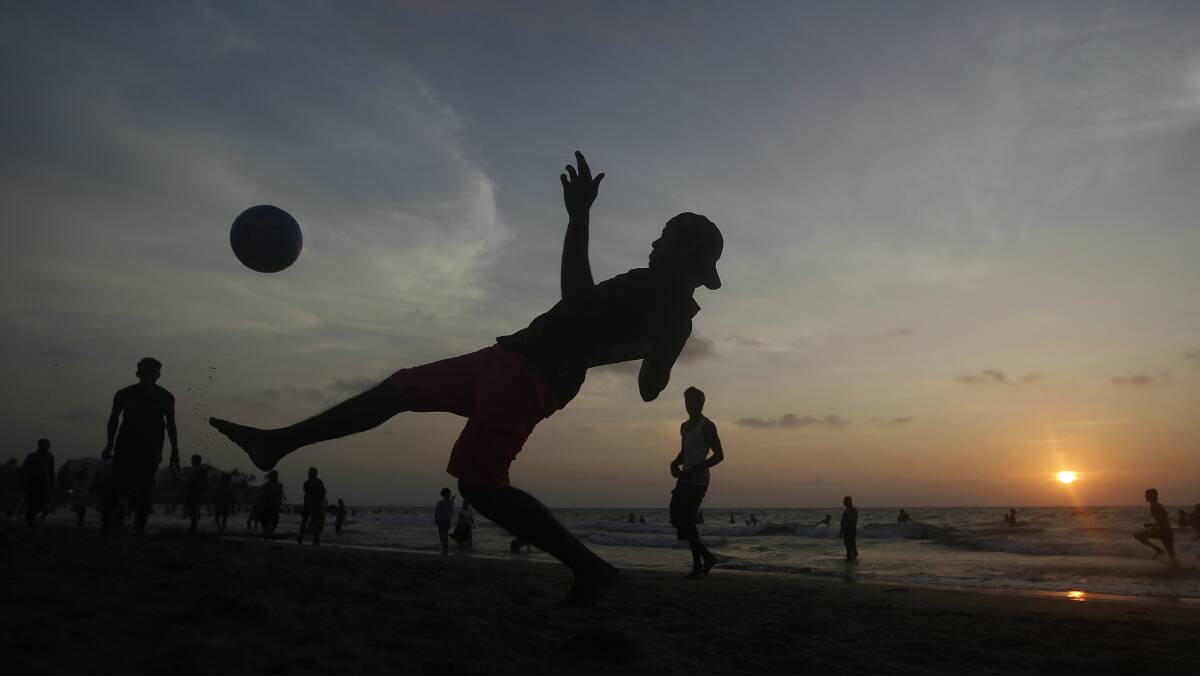 Boys play soccer on a beach in Colombo, Sri Lanka. Picture: REUTERS