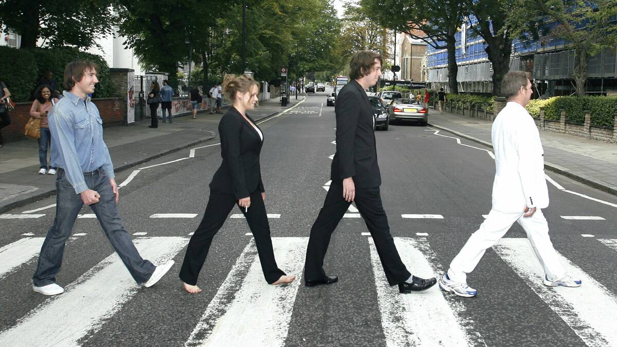 Pedestrians recreate the Beatles' famous album cover. Picture: REUTERS