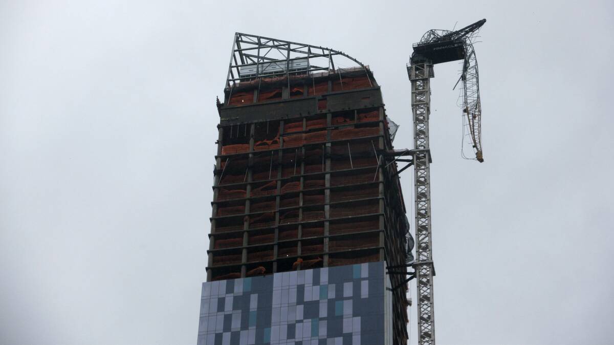 A collapsed crane hangs from a skyscraper in New York City. Picture: REUTERS