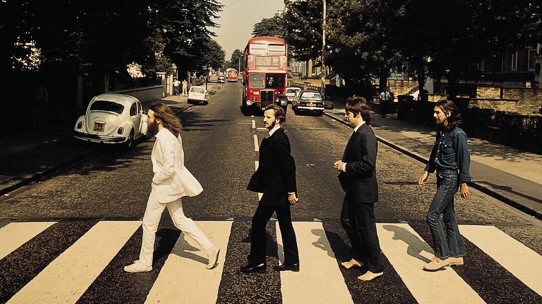 The Beatles use the pedestrian crossing on Abbey Road in London. 