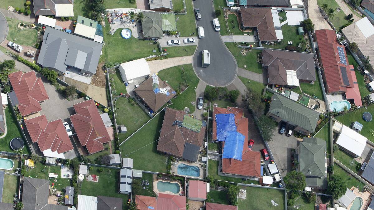  Roofs needed patches on Paperbark Street yesterday. Picture: ANDY ZAKELI
