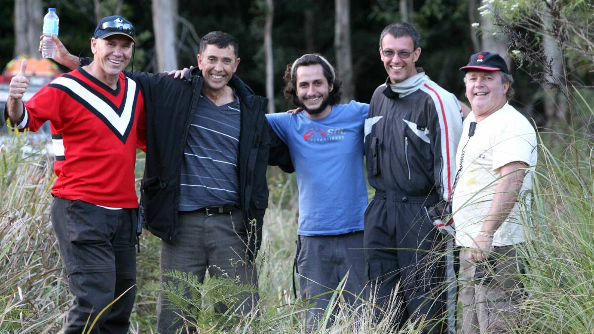 Paraglider Alex Ozkn (second from left) was rescued from Bulli Tops. Pictures: GREG TOTMAN