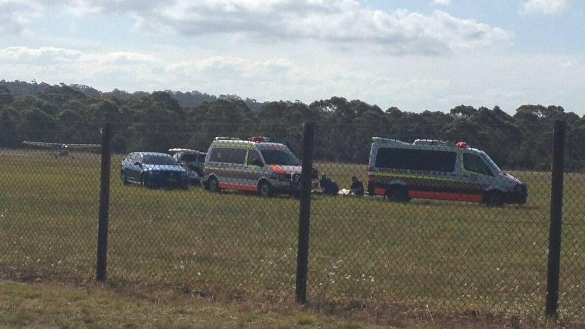 Paramedics attend to the skydiver at Moruya Airport. Picture: BAY POST