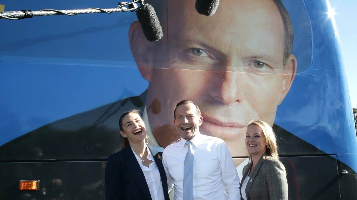 Opposition Leader Tony Abbott (centre) with his daughter Frances (left) and Liberal candidate Fiona Scott at Penrith yesterday. Picture: Alex Ellinghausen