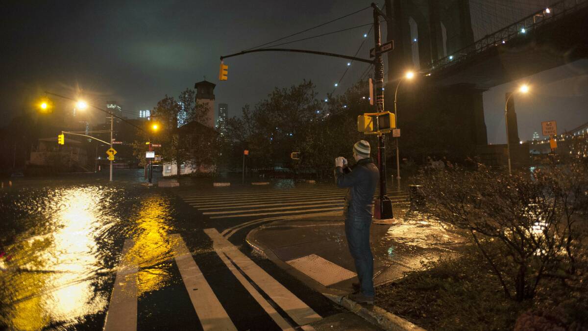 A man takes photos in Brooklyn. Picture: REUTERS