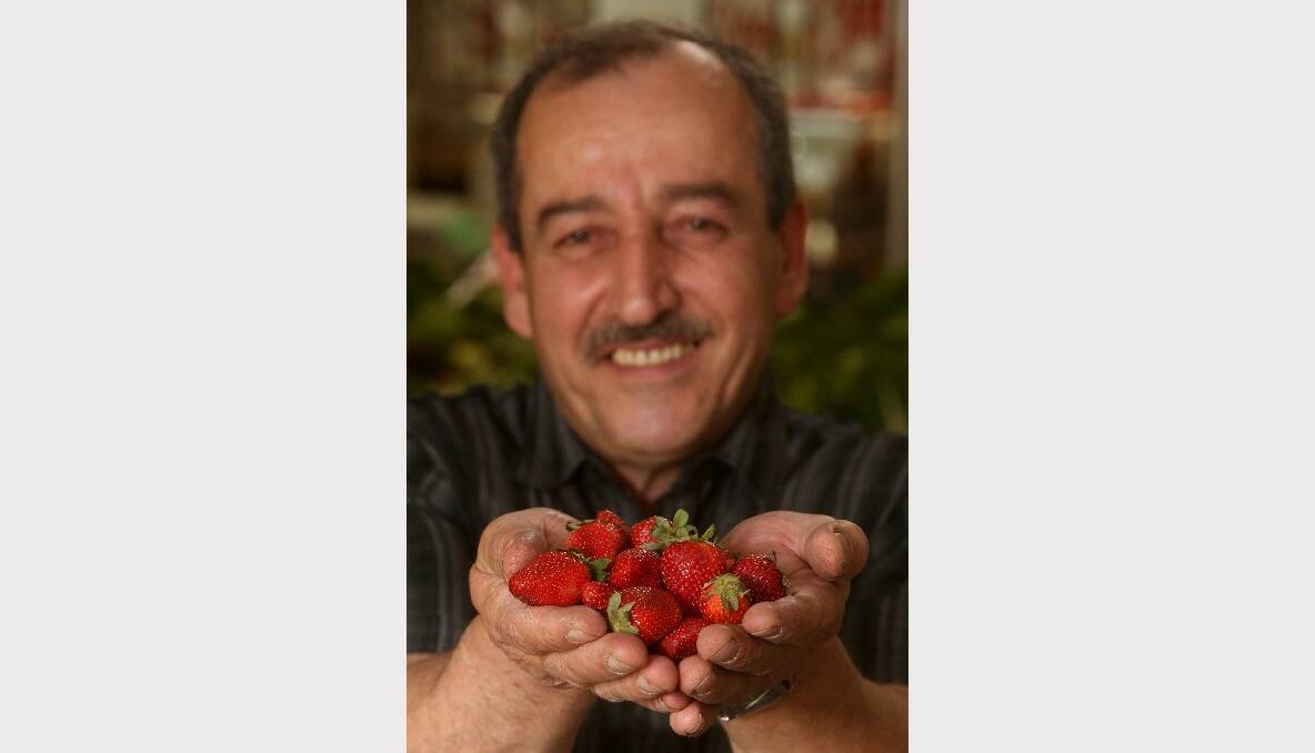 Warrawong fruiterer Bob Gabriel with some fresh strawberries. Picture: ROBERT PEET