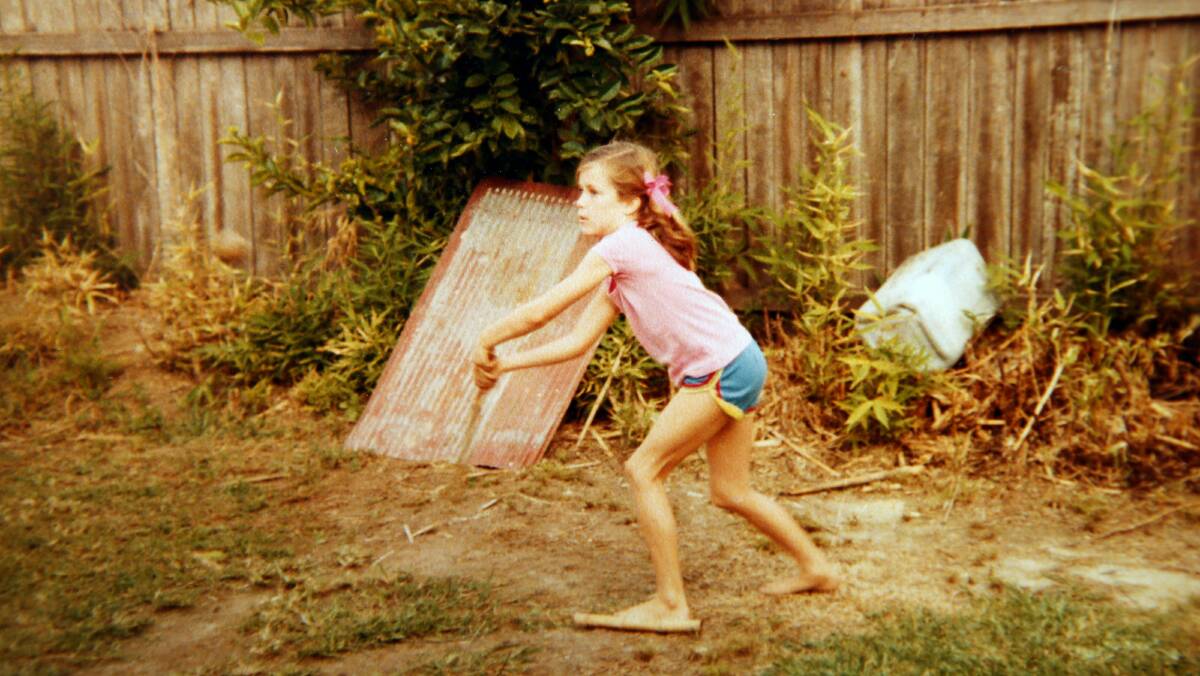 Rachael Mogan McIntosh playing backyard during a childhood holiday. 