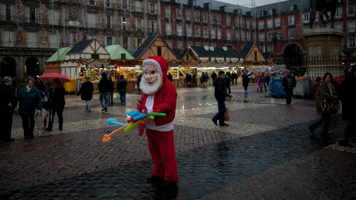 A person dressed as Santa at a market in Madrid, Spain. Picture: GETTY IMAGES
