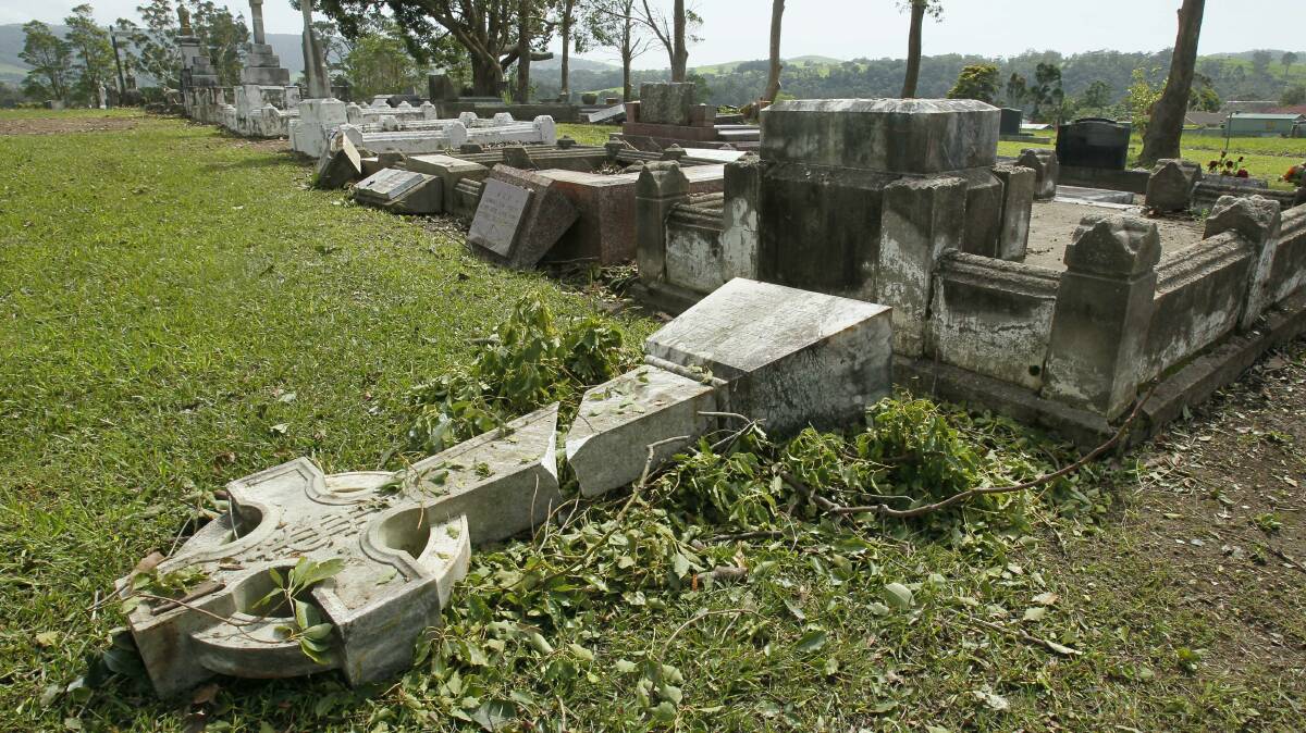Gravestones in Jamberoo damaged by the storm. Pictures: DAVE TEASE